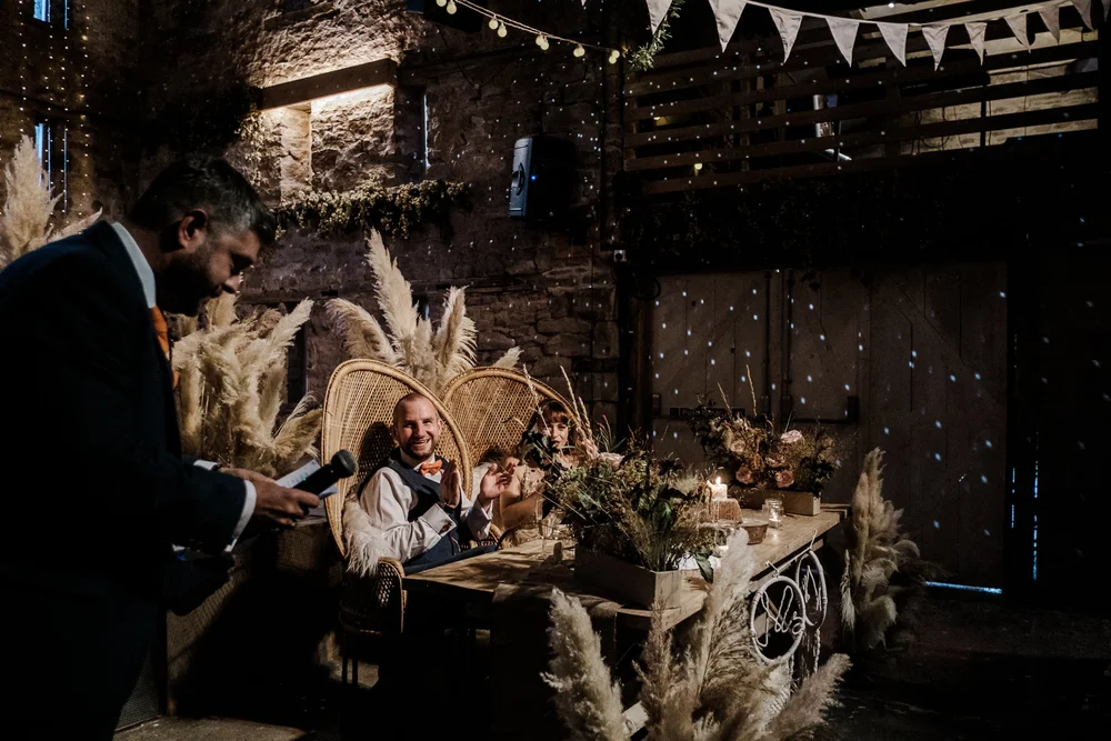 Jess and Tom listening to the speeches in the barn at Lyde Court
