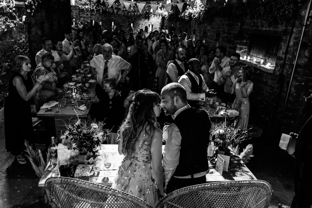 Black and white photograph of guests during the wedding breakfast at Lyde Court
