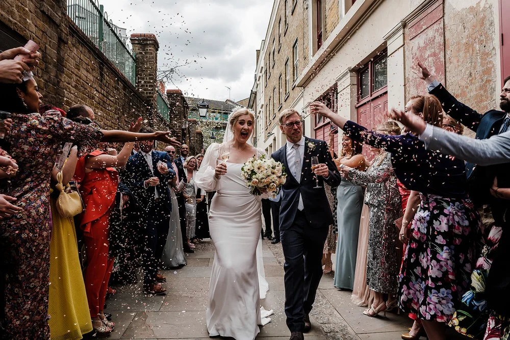 Confetti thrown over Meg and Jamie in the alley outside Wilton&rsquo;s Music Hall