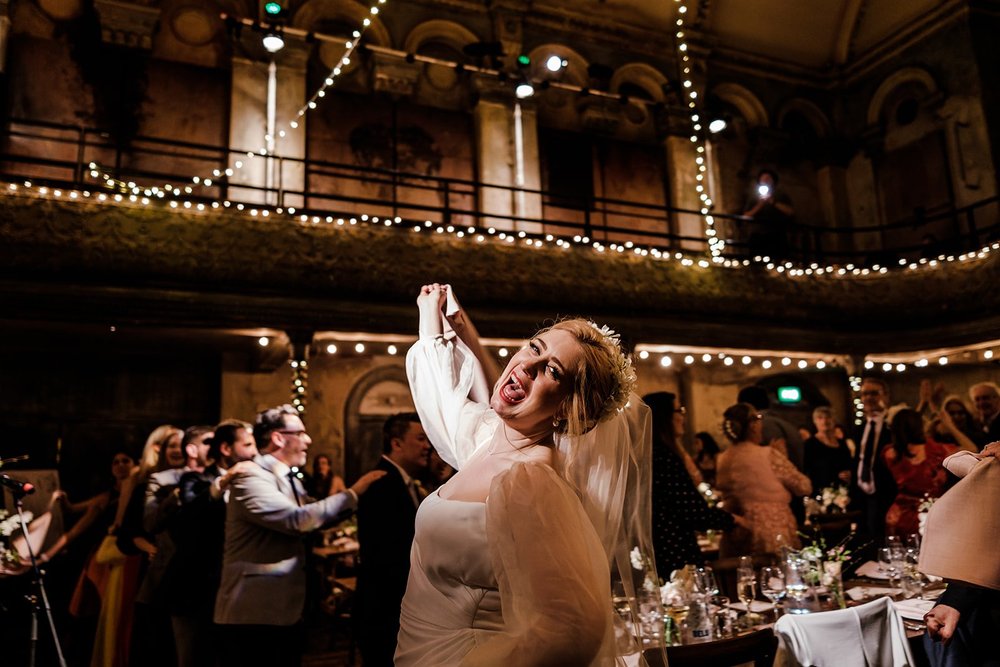 Guests celebrating in the balconied hall at Wilton&rsquo;s Music Hall