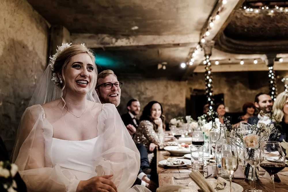 Meg smiling during the wedding breakfast at Wilton&rsquo;s Music Hall