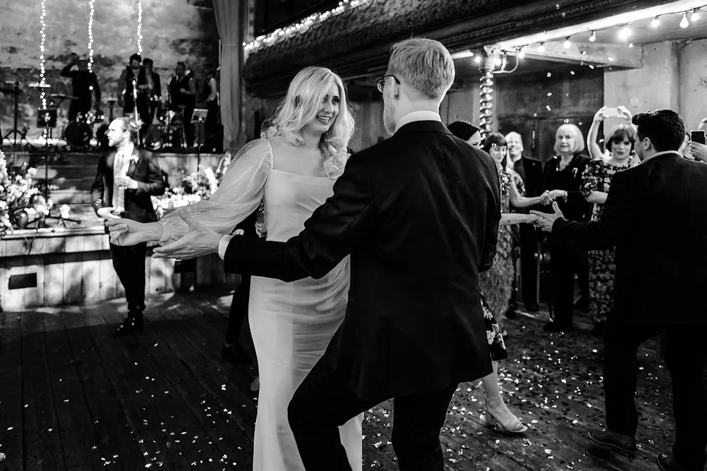 Black and white photograph of Meg and Jamie dancing in the hall