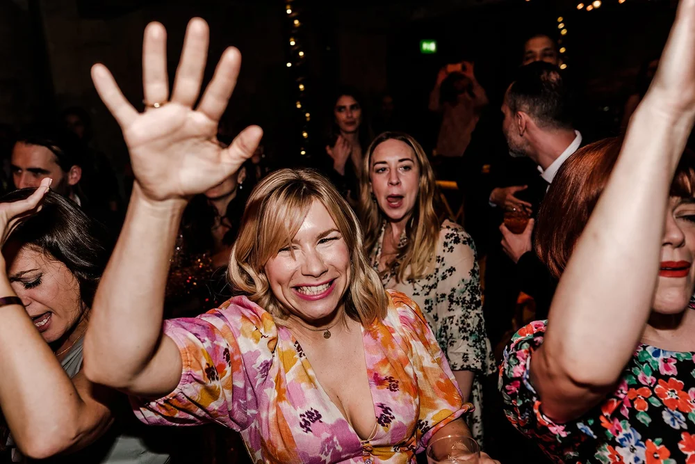 A guest with her hands in the air on the dance floor at Wilton&rsquo;s Music Hall