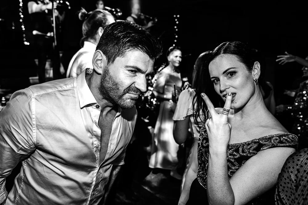 Black and white photograph of two guests at the end of the night