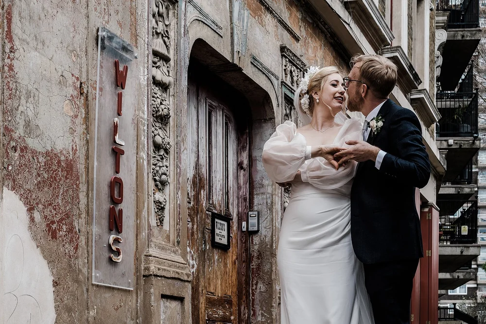 Meg and Jamie beside the Wilton&rsquo;s sign on Graces Alley
