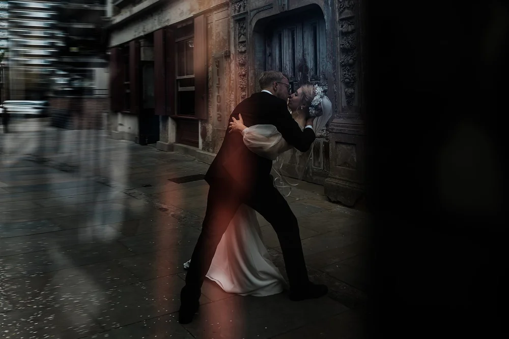 Black and white photograph of Meg and Jamie dancing in a doorway at Wilton&rsquo;s Music Hall