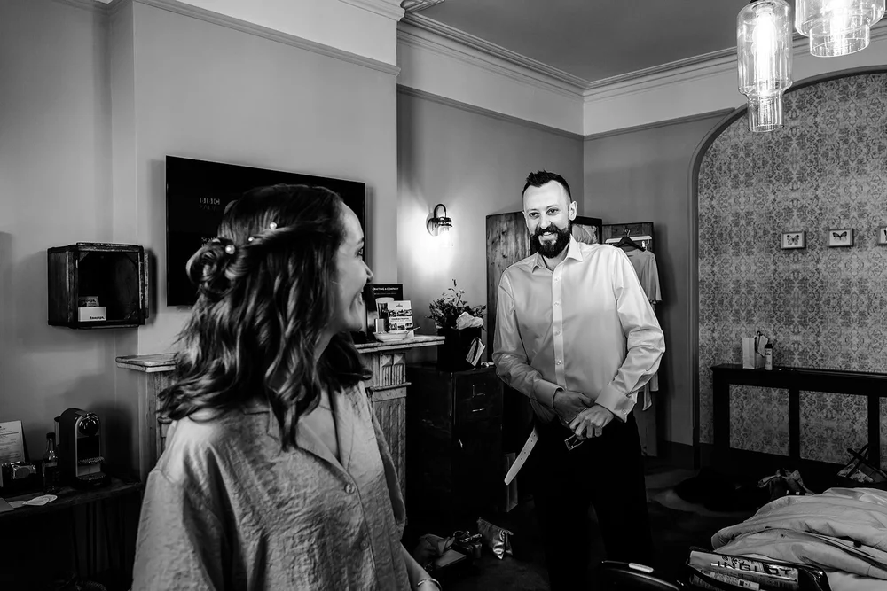 Black and white photograph of Aidan and Charlotte getting ready together