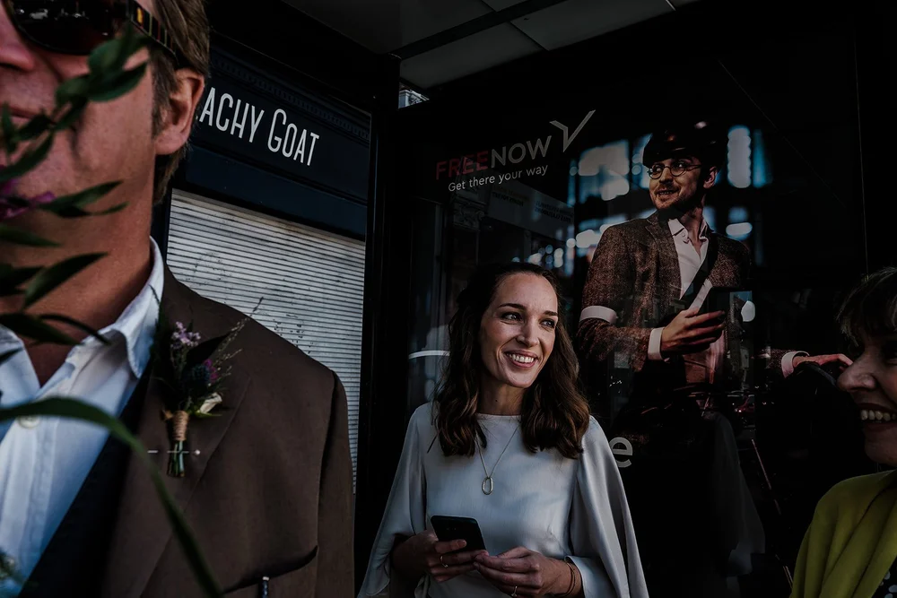 Aidan and Charlotte walking past a shopfront on the way to Lambeth Town Hall