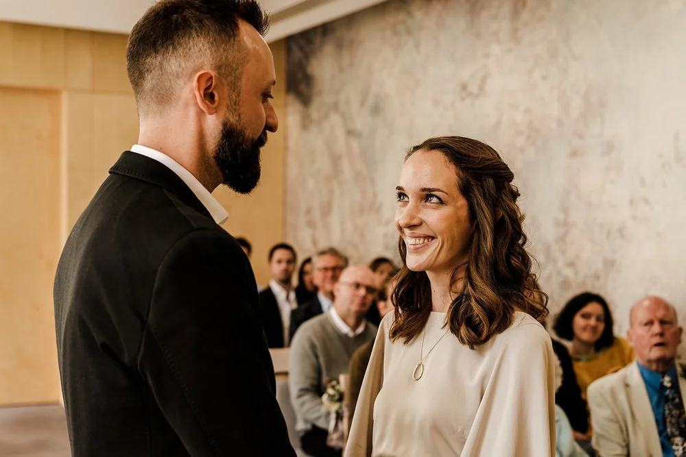 Aidan and Charlotte facing each other during their ceremony at Lambeth Town Hall