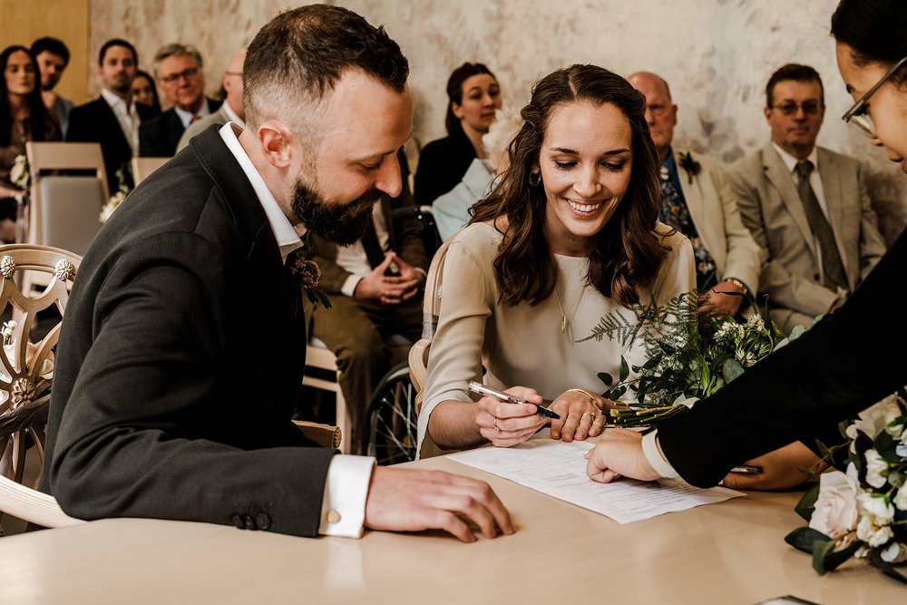 Aidan and Charlotte signing the register at Lambeth Town Hall