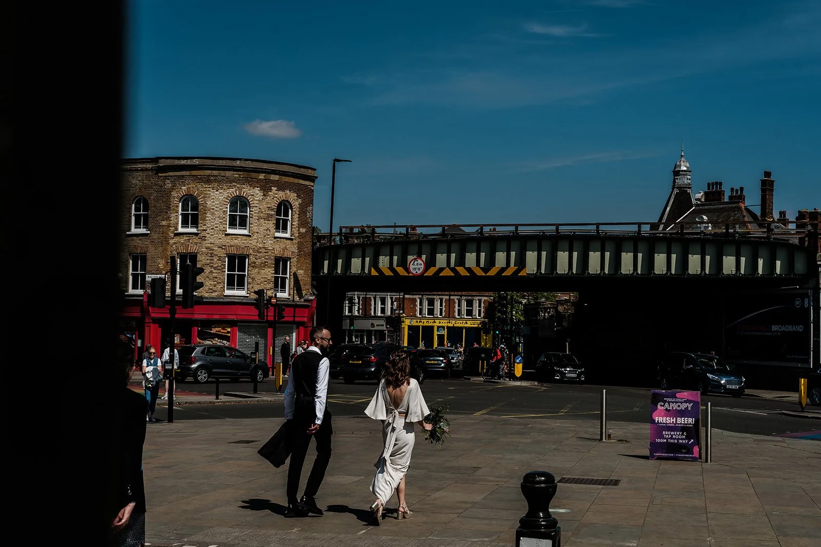 Aidan and Charlotte crossing the road in Brixton after their ceremony