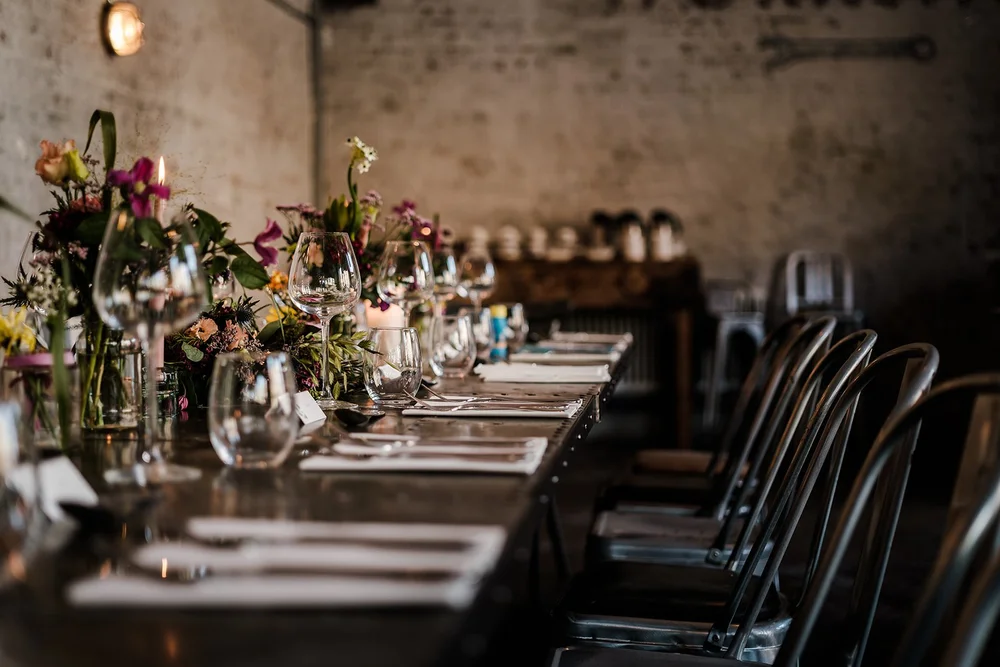 Wildflowers and place settings along the table at The Workshop at the Half Moon