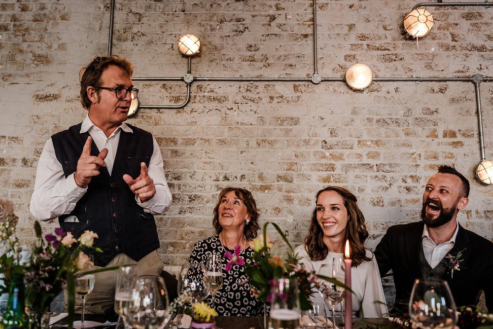 Guests laughing during the speeches at The Workshop at the Half Moon in Herne Hill