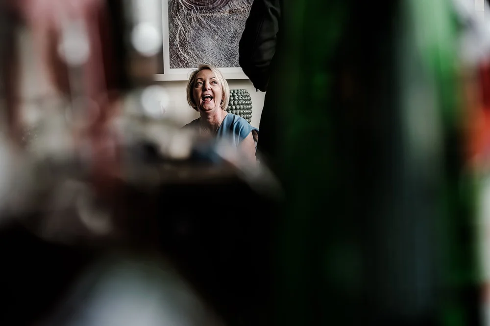A guest photographed through glass during the reception