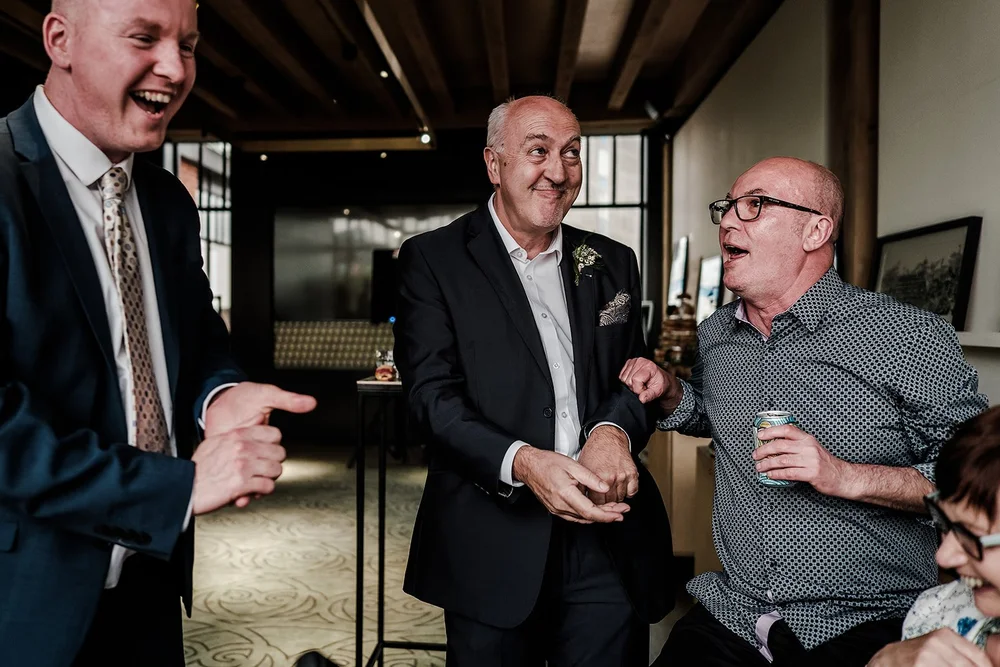 Guests laughing together during the evening reception