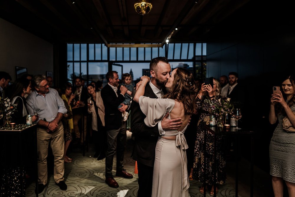 Aidan and Charlotte dancing with guests around them in the evening