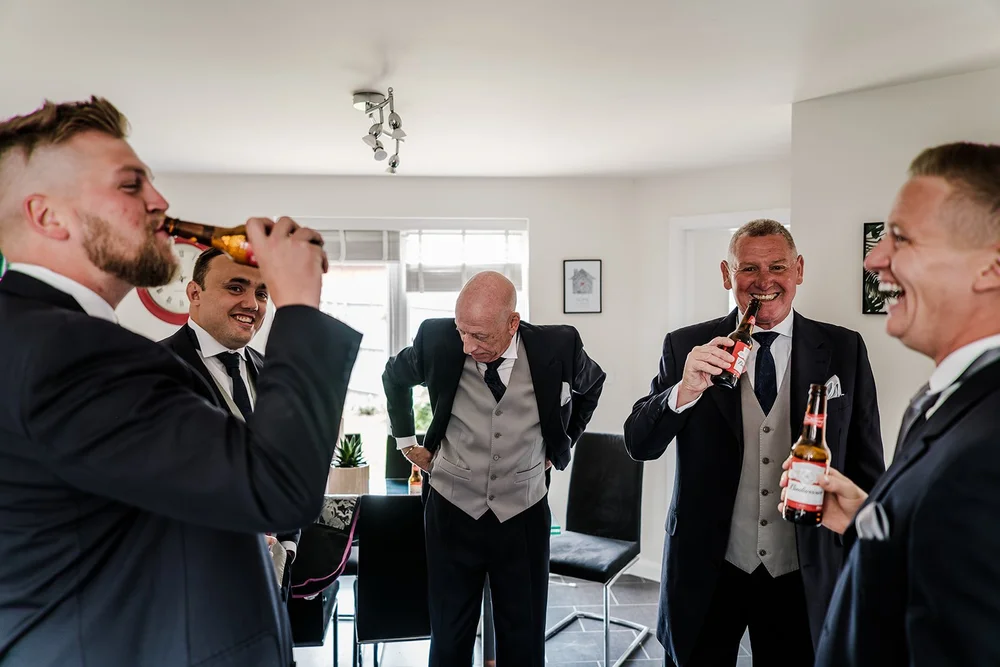 Tom and his groomsmen sharing a drink before the ceremony