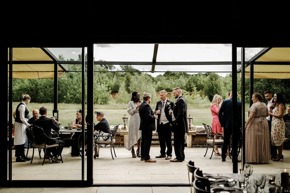 The glazed reception space at Willow Marsh Farm looking out over the fields