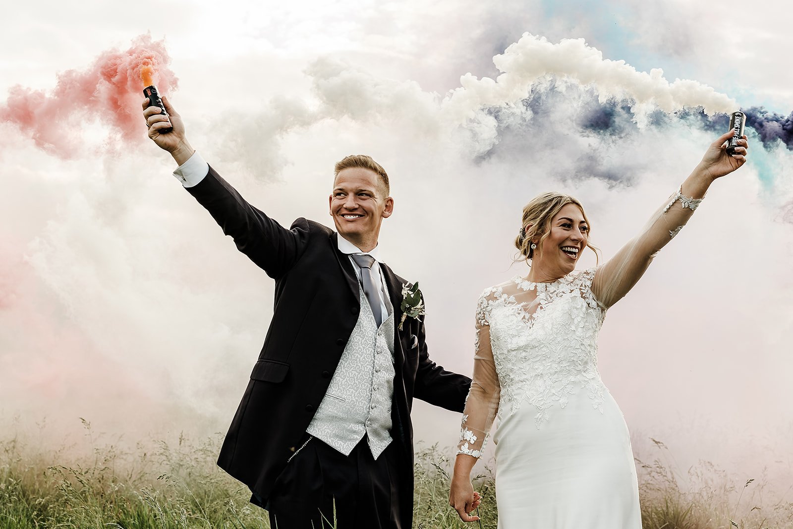 Lauren and Tom setting off coloured smoke grenades in the field at Willow Marsh Farm