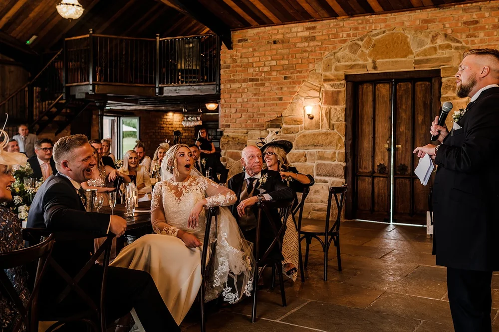 Guests seated at the tables in the barn at Willow Marsh Farm