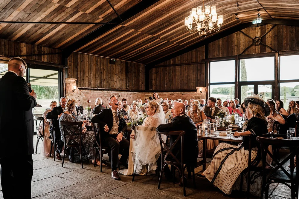Guests during the wedding breakfast in the barn at Willow Marsh Farm