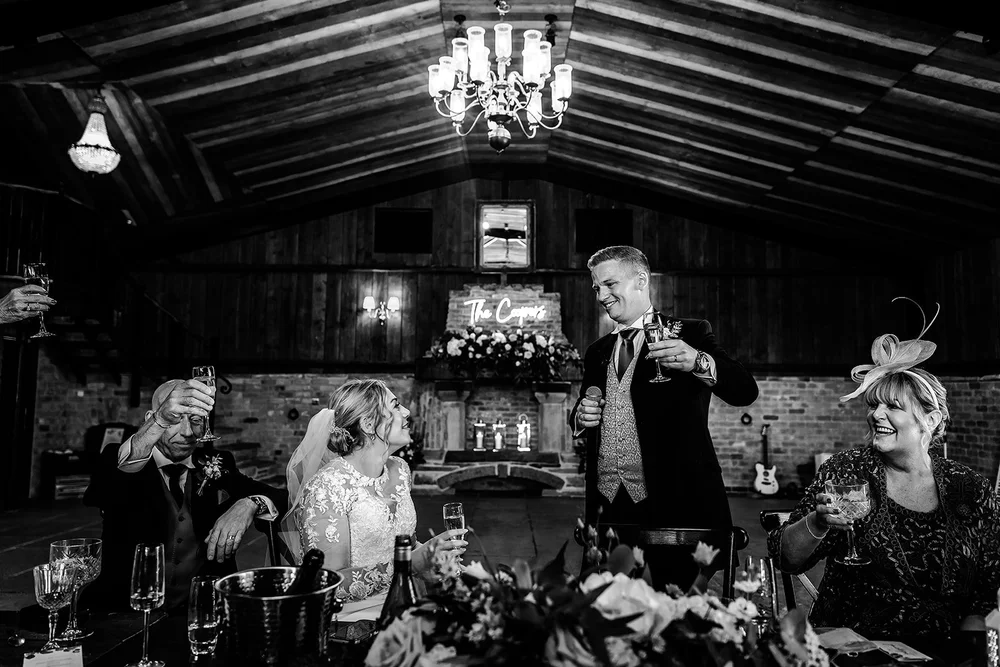Black and white photograph of a speech being given in the barn at Willow Marsh Farm