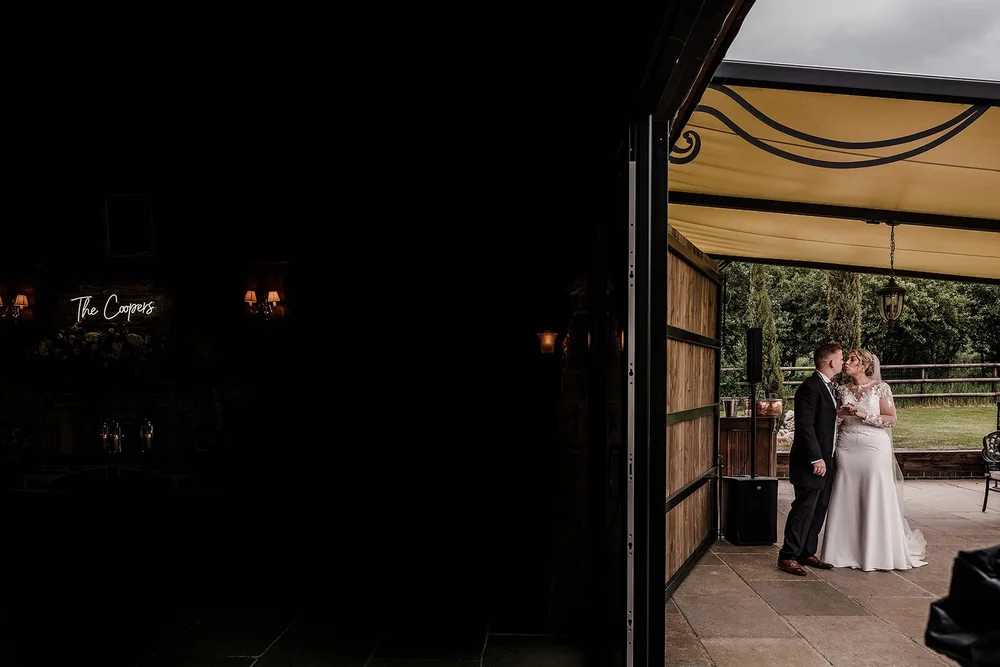 Lauren and Tom framed in the doorway of the barn at Willow Marsh Farm