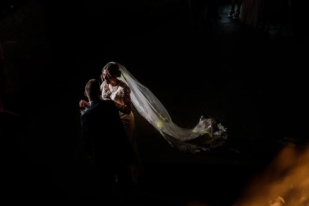 Lauren and Tom dancing with her veil trailing behind her