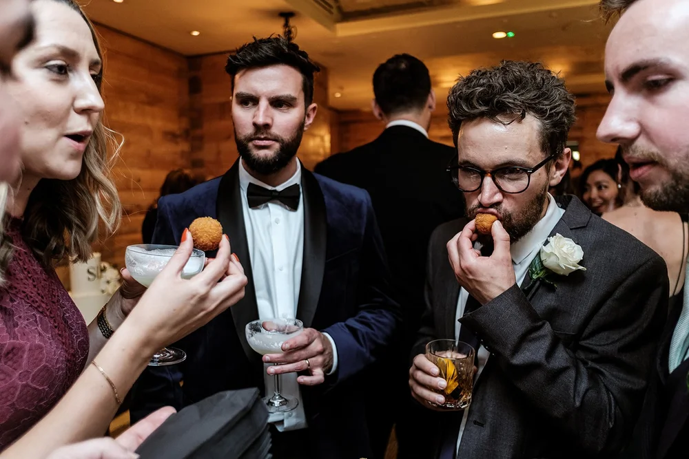 Guests eating canap&eacute;s during the drinks reception at Fortnum & Mason