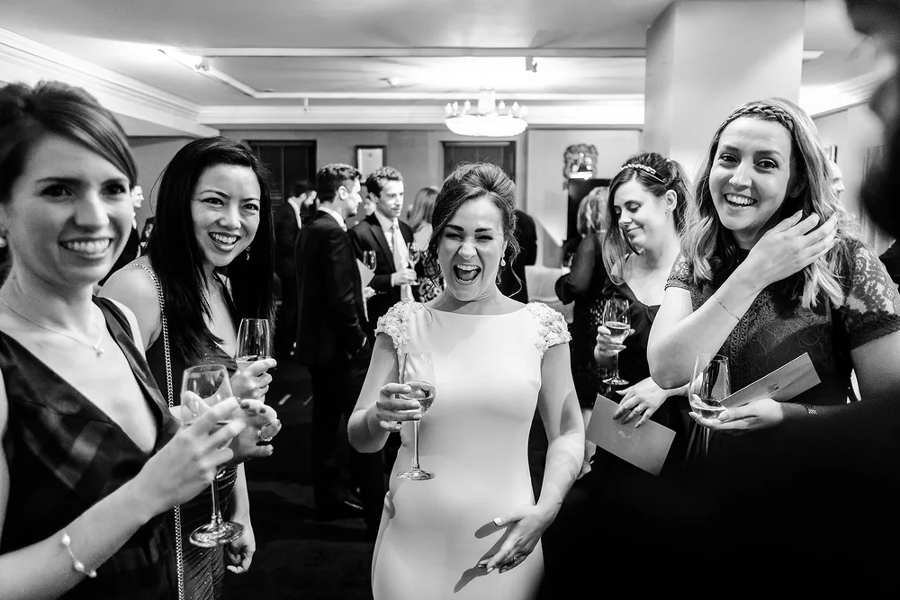 Black and white photograph of guests celebrating with champagne