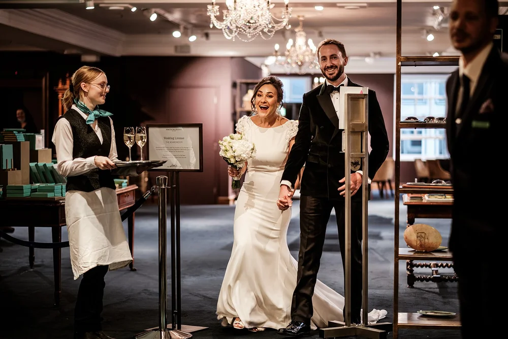 The couple arriving through the doors of Fortnum & Mason