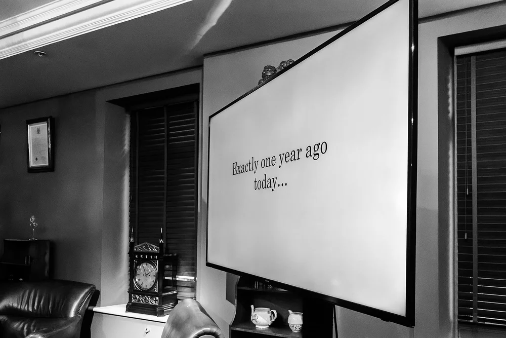A screen reading Exactly one year ago today at the Fortnum & Mason reception