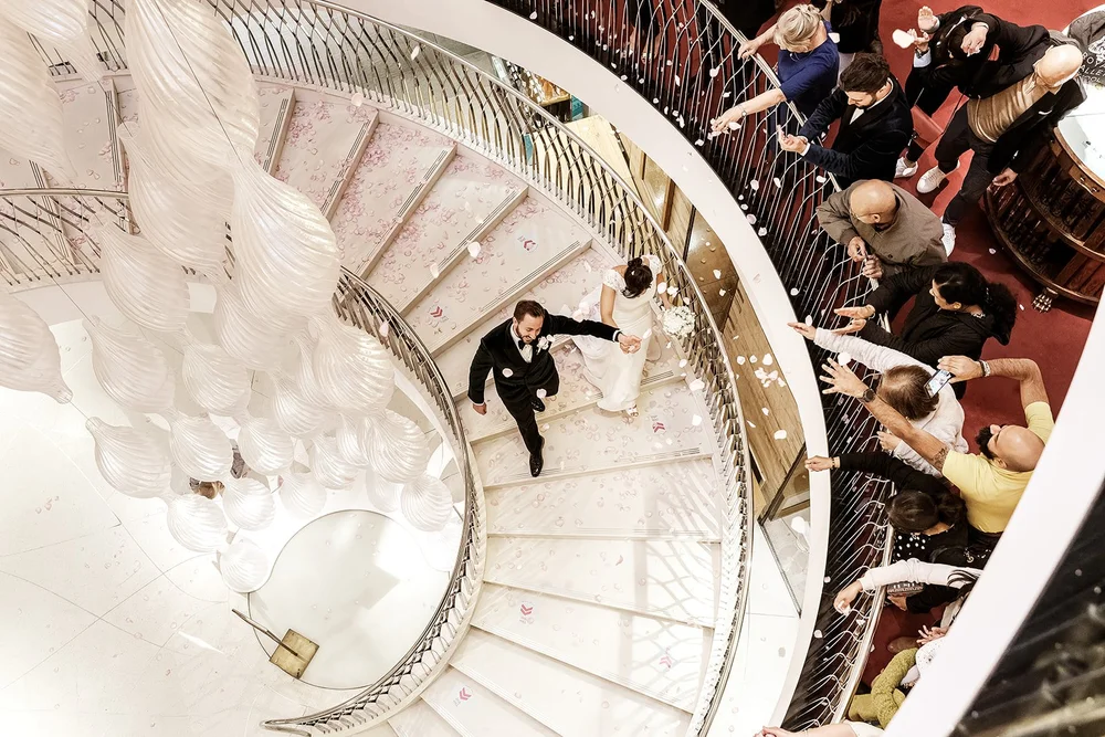 The couple photographed from above on the spiral staircase at Fortnum & Mason