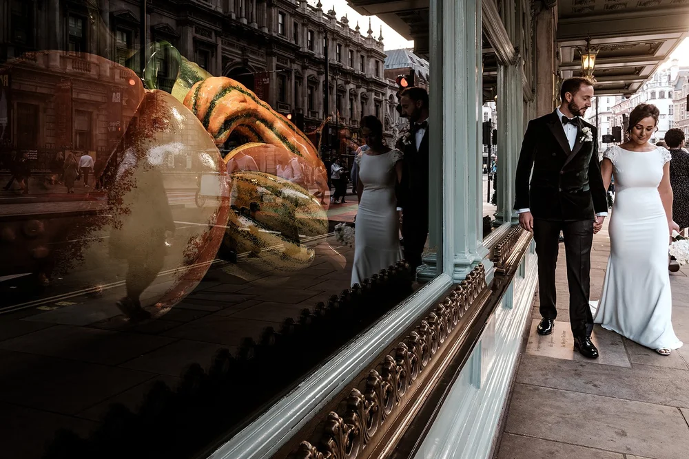 The couple walking past the window display at Fortnum & Mason on Piccadilly