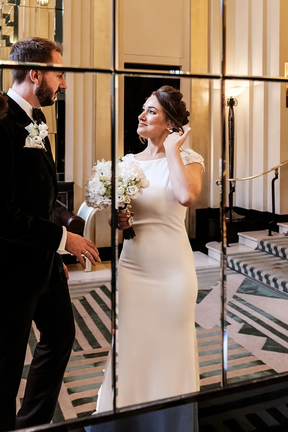 The couple photographed through the mirrors at Claridge&rsquo;s