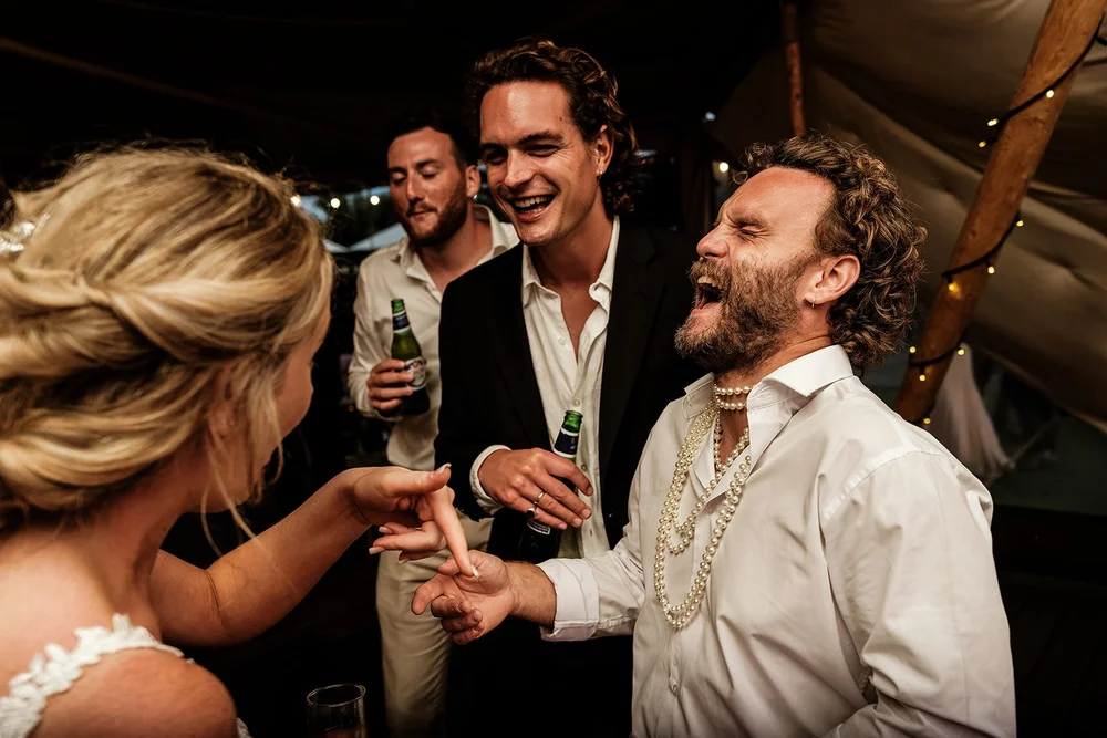 Guests laughing together in the tipi during the evening