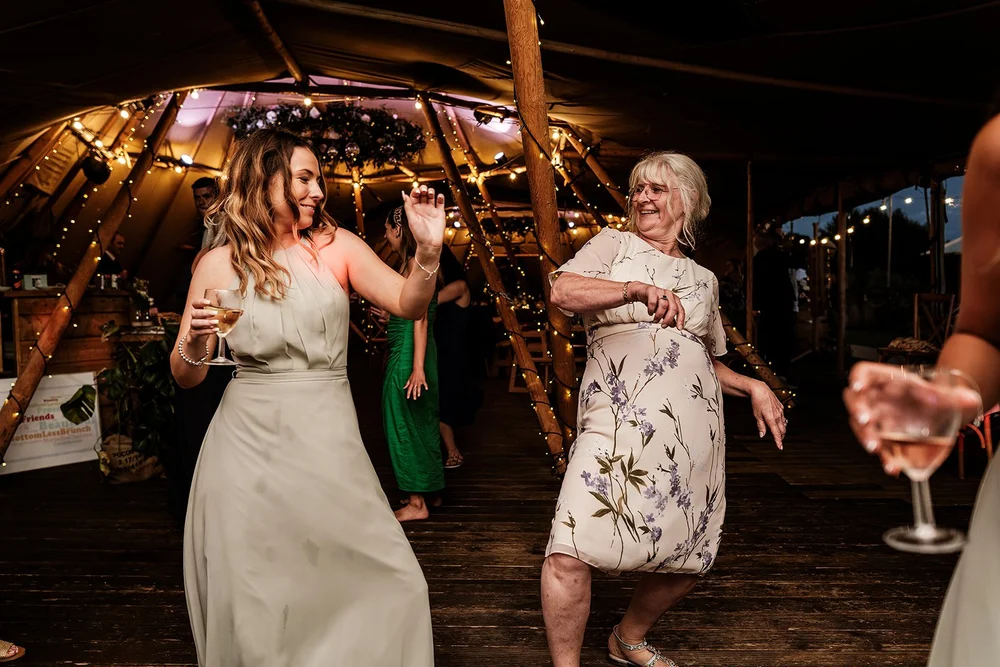 Guests dancing together in the tipi at Hadsham Farm