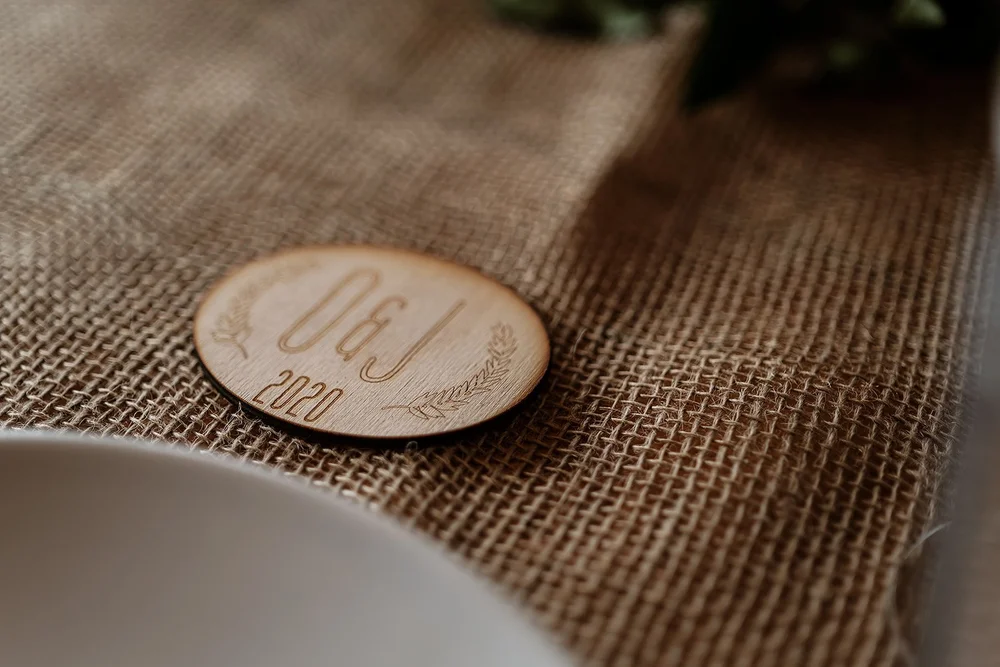 A wooden place setting detail at the wedding breakfast