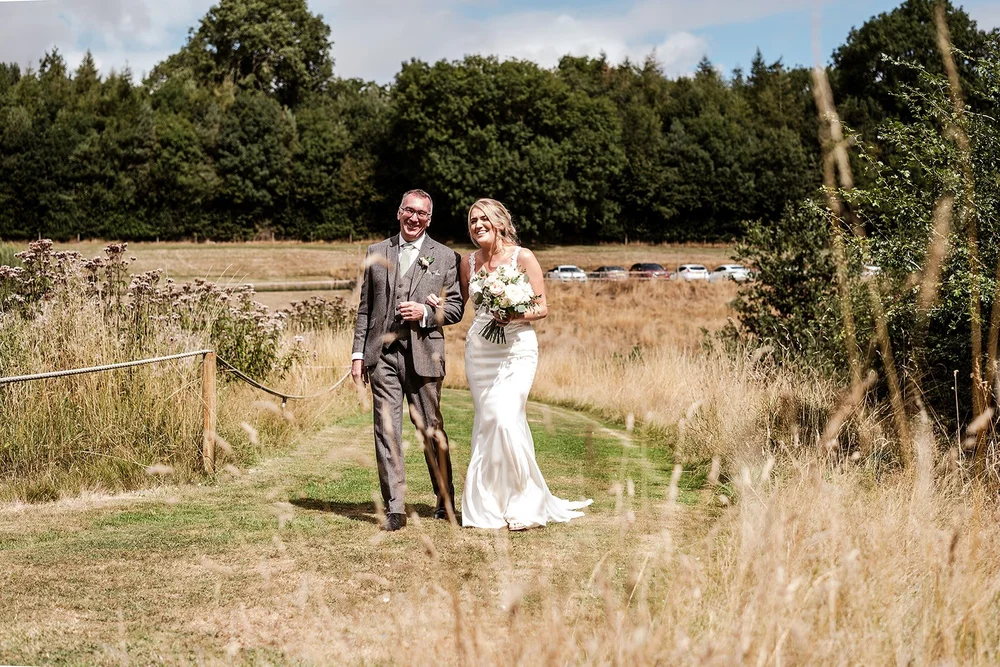 Liv and her father walking through the meadow at Hadsham Farm