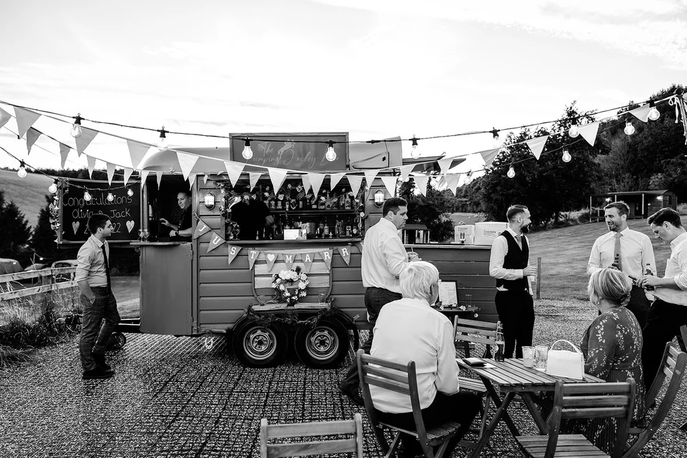 Black and white photograph of the pizza van serving guests at Hadsham Farm