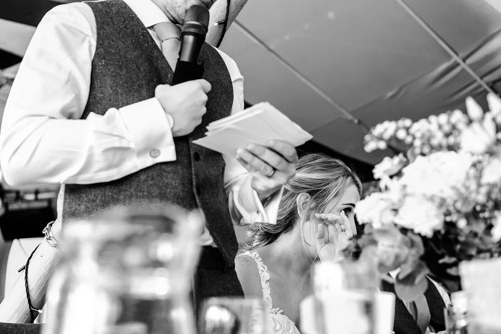 Black and white photograph of a guest during the wedding breakfast