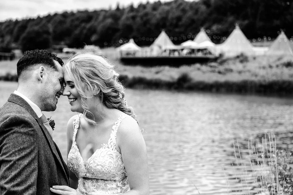 Black and white photograph of Liv and Jack beside the lake at Hadsham Farm