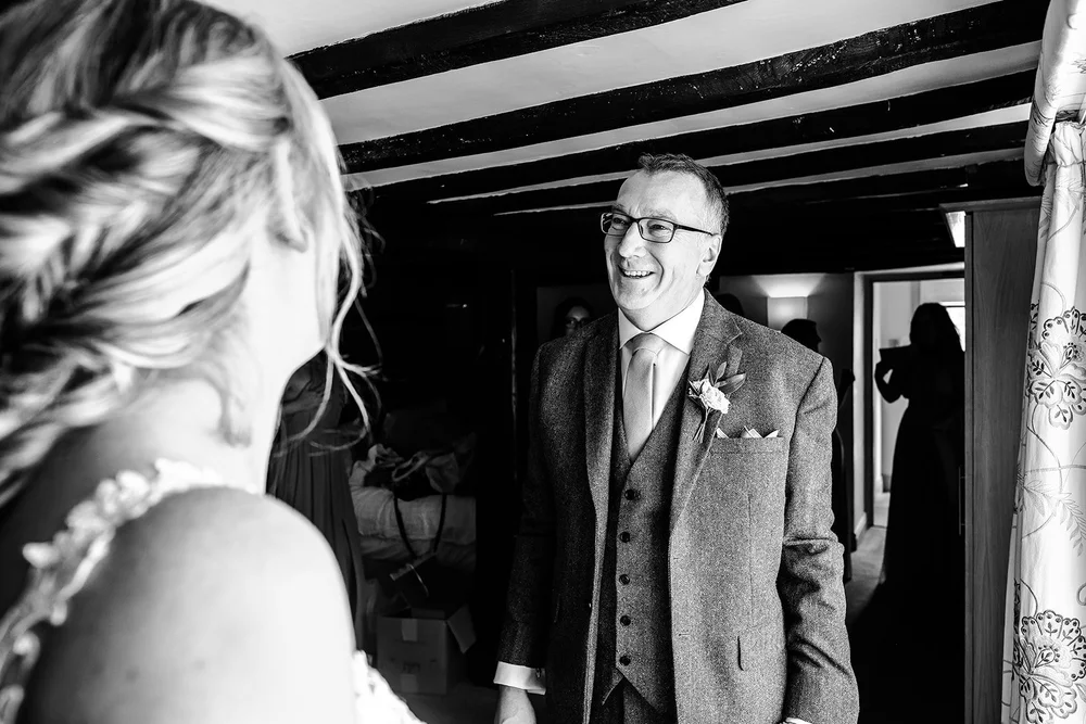 Black and white photograph of Liv&rsquo;s father seeing her in her dress for the first time