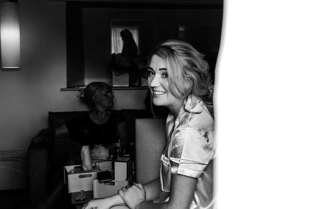 Black and white photograph of Liv at the window before the ceremony
