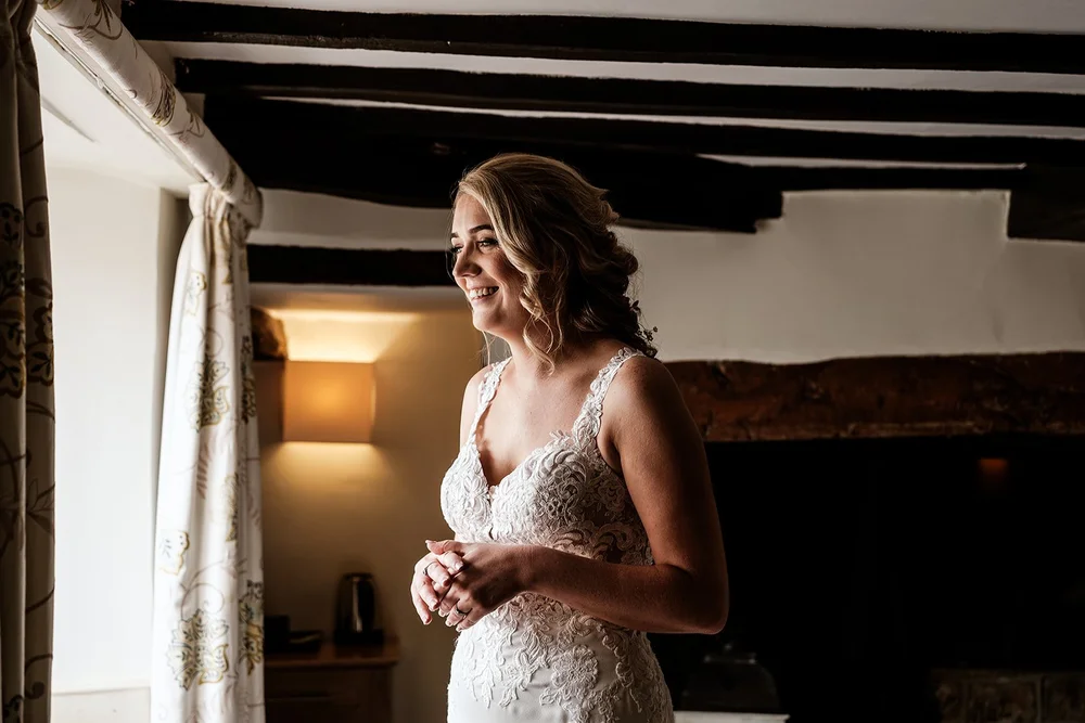 Liv in her wedding dress in the beamed room before the ceremony