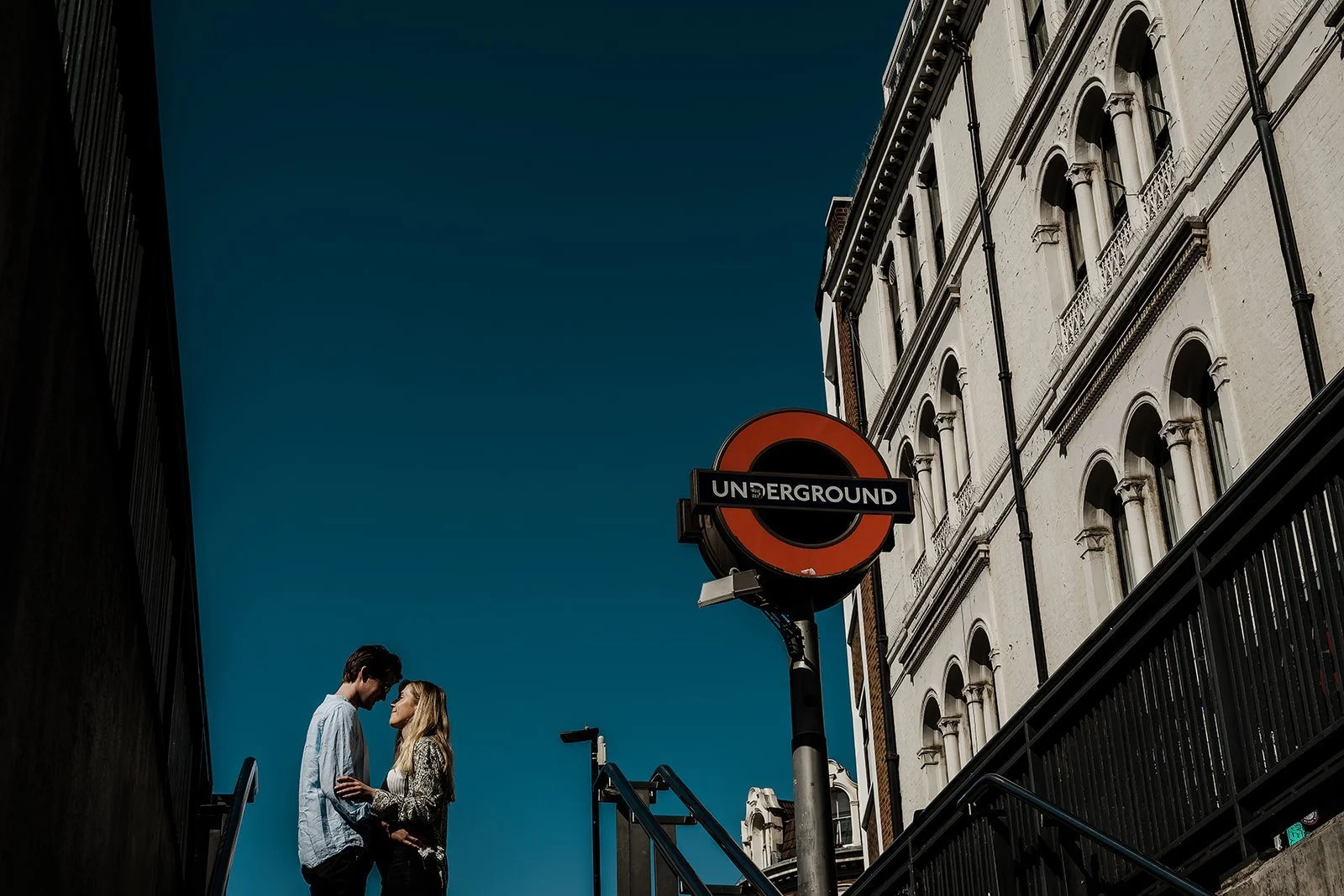 A couple laughing together during a pre wedding photography session in London