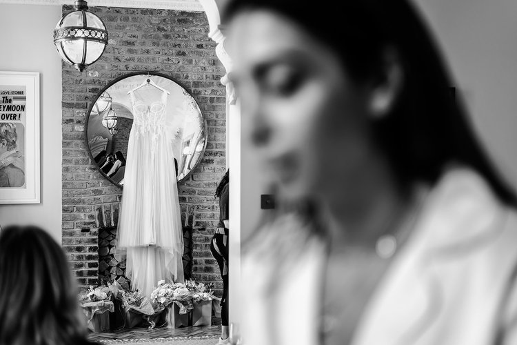 A wedding dress hanging in the brick archway at Brunswick House, Vauxhall