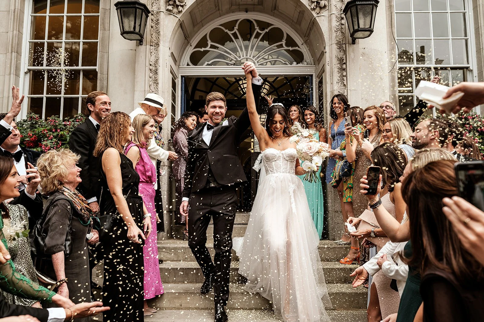 Confetti on the front steps of Chelsea Old Town Hall as a newly married couple walk out onto the King&rsquo;s Road