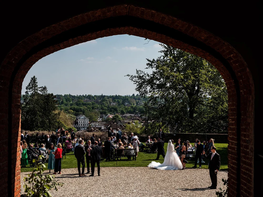 Looking out through the medieval gatehouse arch at Farnham Castle towards the guests