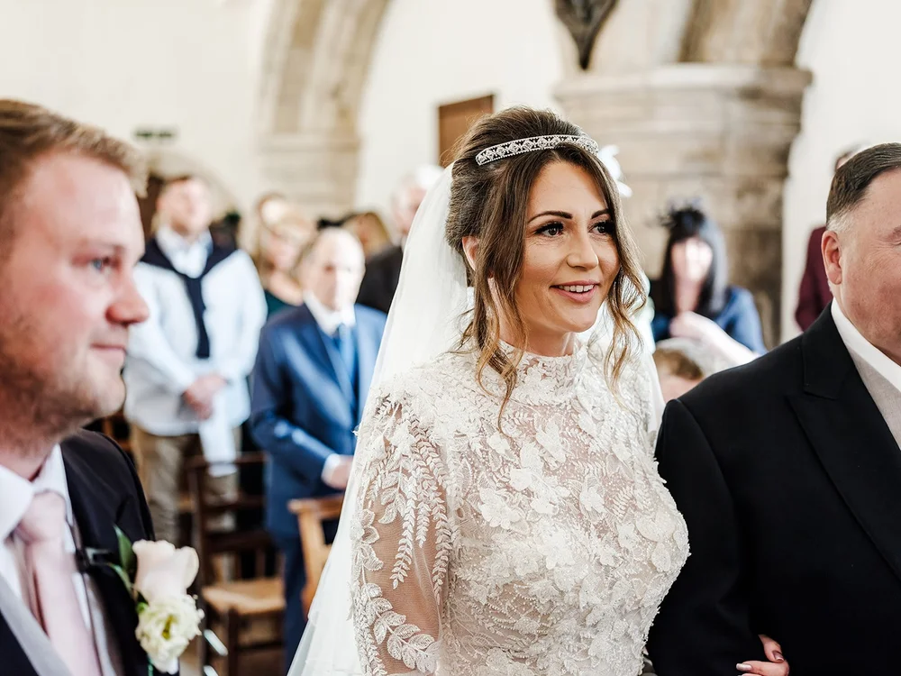 Jade and Guy during their wedding ceremony at Farnham Castle in Surrey